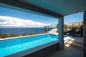 a view of the ocean from a house with a swimming pool at Holiday Home Dona Maria in Prigradica