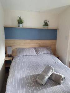 a bed with two potted plants on top of it at Nidd Way Holiday Let in Knaresborough