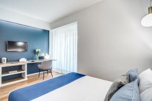 Łóżko lub łóżka w pokoju w obiekcie Victor Boutique Hotel