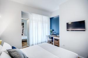 Łóżko lub łóżka w pokoju w obiekcie Victor Boutique Hotel