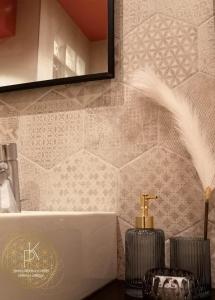 a bathroom with a white tub and a mirror at Appartement Carré d'Or Vue sur Mer in Nice