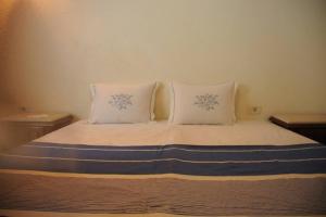 Ein Bett oder Betten in einem Zimmer der Unterkunft Dar Mohcen