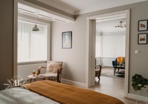 a bedroom with a bed and a living room at Heart of the City - Better Stay Townhouse in Ruse