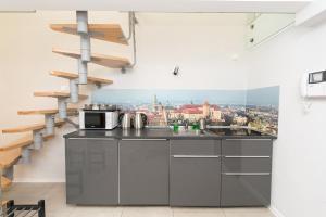 a kitchen with a view of the city at Exclusive Loft in the Main Square A/C p4you pl in Krakow