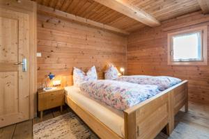 a bedroom with a bed in a log cabin at Ferienwohnung Krösshof in Sarntal