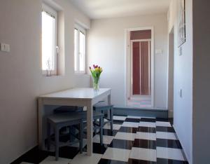 a dining room with a table and a vase of flowers at Hana place in Motovun
