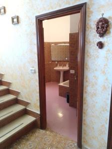 a bathroom with a toilet and a sink and a mirror at Villa Lembo in Agnone +63 photos