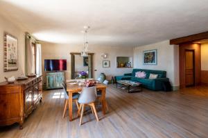 a living room with a table and a blue couch at Villa Rosmarino in Imperia