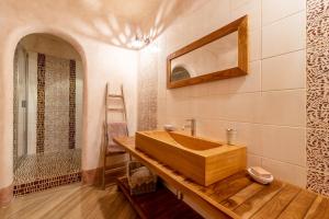 a bathroom with a wooden sink and a mirror at Villa Rosmarino in Imperia +19 photos