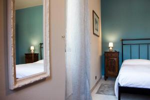 A bed or beds in a room at L'Aromatario