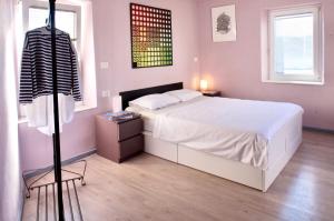 a bedroom with a large white bed and a dresser at Hana place in Motovun +9 photos
