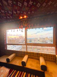 a bench in a room with a large window at Arabian Nights in the heart of historic Alexandria in Alexandria