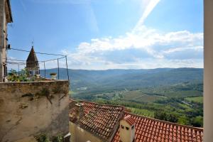 a view of the hills from a building with roofs at Hana place in Motovun