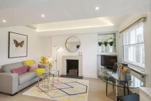 a living room with a couch and a fireplace at Marylebone - Crawford Street by Viridian Apartments in London