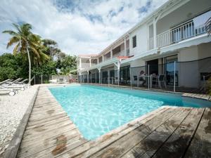 a large swimming pool in front of a building at Coco Beach Marie-Galante in Grand-Bourg
