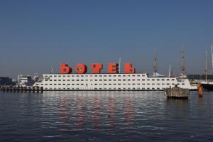 a large cruise ship sitting in the water at Botel in Amsterdam
