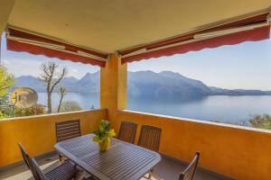 a table on a balcony with a view of a lake at Residence Villa Ada Holiday C208 in Ghiffa