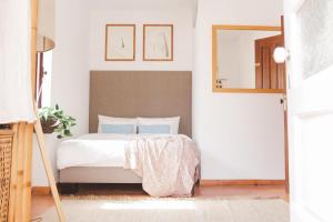 a bedroom with a bed and a mirror at WOT Ericeira Lodge in Ericeira