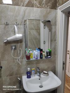a bathroom with a sink and a mirror at Guest house boulevard 1 in Sumqayıt +11 photos