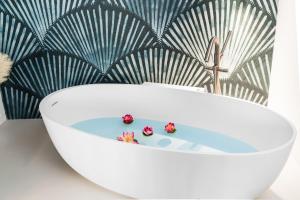 a white bath tub with two strawberries in it at MADA Charm Apartments Piazza in Vernazza