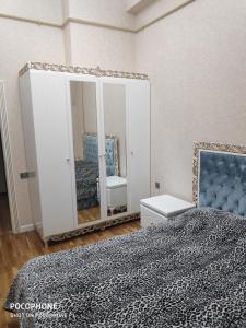 a bedroom with a mirror and a bed at Guest house boulevard 1 in Sumqayıt