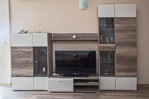 a large entertainment center with a flat screen tv at Sea view Obzor Beach apartment in Obzor