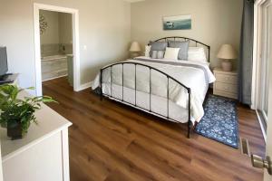a bedroom with a bed and a wooden floor at Condo on Lake Keowee with Resort Amenities and Pool! in Salem +19 photos
