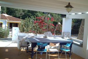 a blue table and chairs on a patio at Preciosa casa en primera línea del mar in Biniatap de Dalt