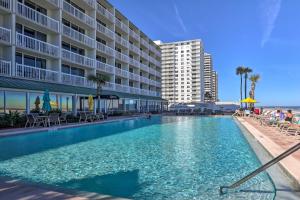a large swimming pool in front of a hotel at Daytona Beach Resort Studio with Ocean View and Pools! in Daytona Beach