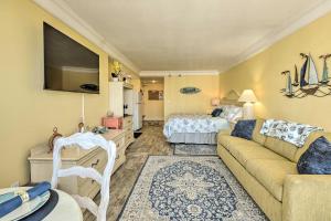 a living room with a couch and a bed at Daytona Beach Resort Studio with Ocean View and Pools! in Daytona Beach