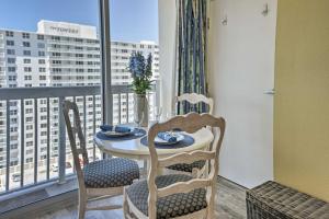 a table and chairs in a room with a window at Daytona Beach Resort Studio with Ocean View and Pools! in Daytona Beach
