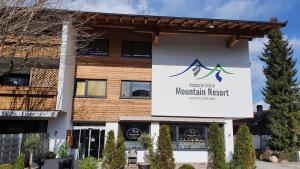 a sign for the mountain resort on the side of a building at Absolute Active Mountain Resort in Kirchberg in Tirol