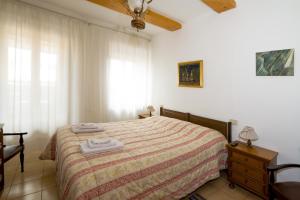 a bedroom with a bed with two towels on it at Cheap Apartment in The Old Village in Colle Val D'Elsa