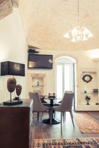 a dining room with a table and chairs at 800s Home Luxury Rooms in Ostuni
