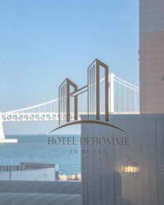 a hotel bathroom in boston with a bridge in the background at De Homme Hotel in Busan