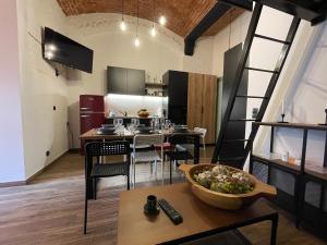 a kitchen with a table with a bowl of food on it at ApartmentSun Loft Factory in Wrocław