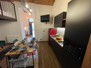 a kitchen with a table with plates on it at ApartmentSun Loft Factory in Wrocław