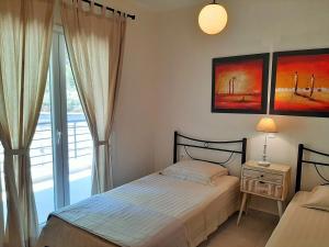 a bedroom with a bed and a window at Bel Air in Skala Potamias