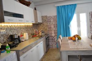 a kitchen with a table with fruit on it at Michalis Captain Home in Agia Galini