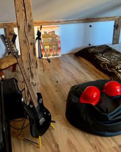 a room with a guitar and a helmet and a guitar at Pasta Loft apartments in Liepāja