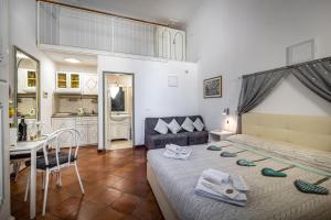 a bedroom with a bed and a table and a kitchen at Duomo Palace in Florence