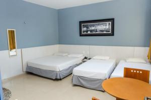 Tempat tidur dalam kamar di San Fernando Hotel