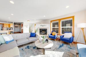 a living room with a white couch and blue chairs at Blue Wave Heights in Lincoln City