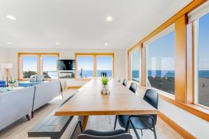 a dining room with a long table and chairs at Blue Wave Heights in Lincoln City