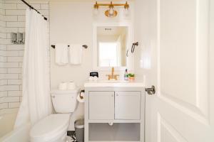 a bathroom with a sink and a toilet and a mirror at Unit 1 - Spacious & Renovated Apt Home in the City's Action in Houston +22 photos