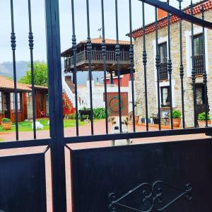 a gate to a building with a dog behind it at El Perlindango in Villademar