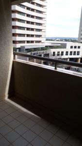 a balcony in a building with a large window at Apartamento no condomínio do Brasil 21 Suites in Brasilia