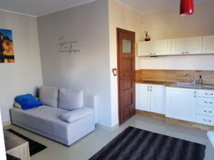 a living room with a couch and a sink at Studio Gdańsk in Gdańsk