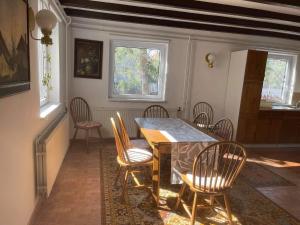 a dining room with a table and chairs at Iluska Vendégház in Kiskunmajsa