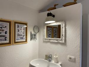 a bathroom with a sink and a mirror at La Finestra sul Fiume in Valeggio sul Mincio
